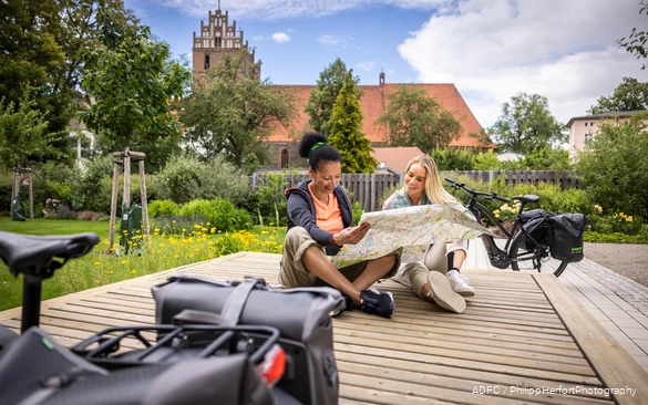 Bett & Bike Zwei Frauen Karte Zwei Radfahrerinnen schauen sich eine Radkarte im Sauerland in einen Bett&Bike Betrieb ein.